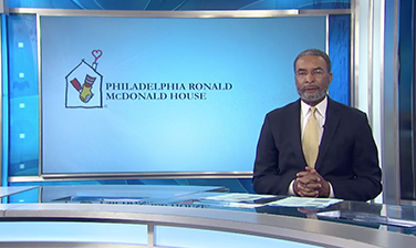 CBS Philadelphia anchor at desk, Philadelphia Ronald McDonald House logo on screen